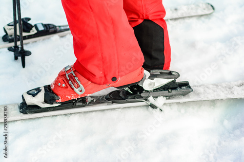 Closeup of skis closeup on human leg.