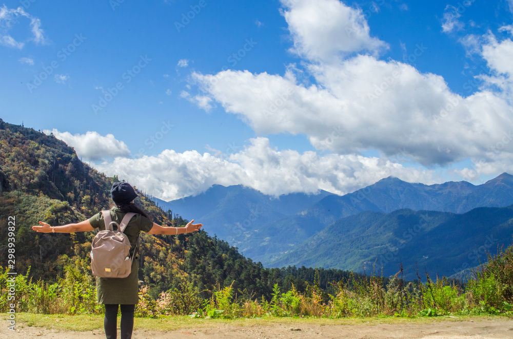 Female traveller wandering in Chele la pass in Bhutan to enjoy the tranquil of serene mountains Female traveller wandering in Chele la pass in Bhutan to enjoy the tranquil of serene mountains