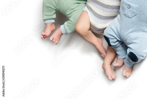 Photos three pairs of legs of newborn babies triplets