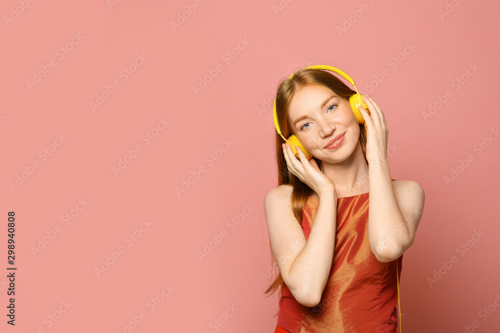 Portrait of beautiful young woman with headphones on pink background, space for text - obrazy, fototapety, plakaty 