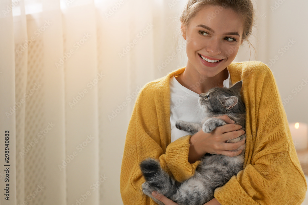 Young woman with cute cat at home. Cozy winter Young woman with cute cat at home. Cozy winter