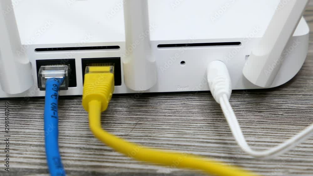 White Wireless Wi-Fi Router And Cables On The White Desk Panning Slider Shot. White Wireless Wi-Fi Router And Cables On The White Desk Panning Slider Shot.