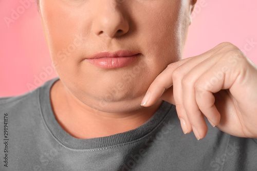 Woman with double chin on pink background, closeup