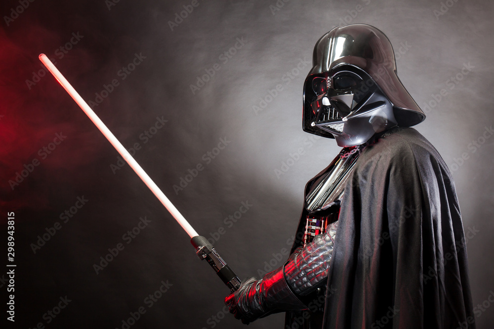 Fotka „SAN BENEDETTO DEL TRONTO, ITALY. MAY 16, 2015. Portrait of Darth  Vader costume replica with his sword. Darth Vader or Dart Fener is a  fictional character of Star Wars saga.“ ze