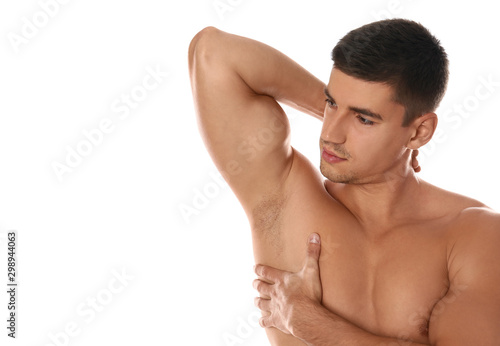 Handsome man showing hairy armpit on white background. Epilation procedure