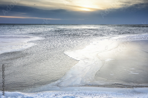 sunlight over very big frozen lake in winter