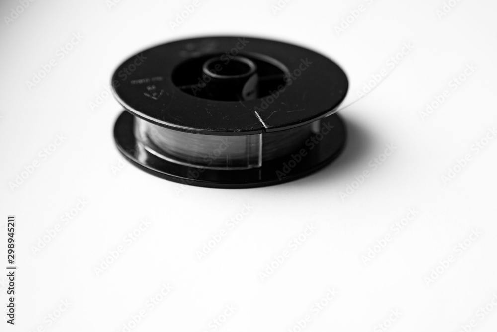 fishing line on reel lying on light background fishing line on reel lying on light background