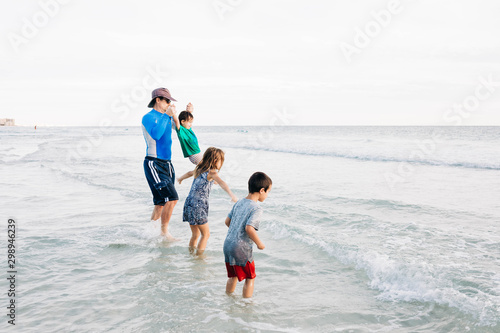Father with Children Playing in the Ocean