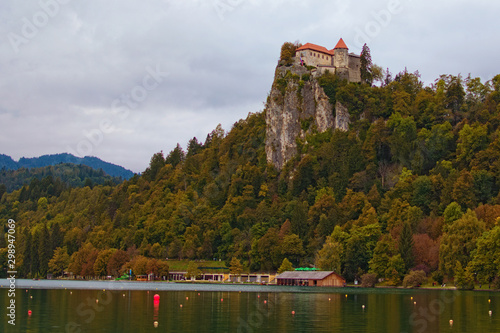 Picturesque autumn landscape view of ancient Bled Castle on the top of the cliff. Cloudy sky in the background. Famous touristic place and romantic travel destination in Slovenia © evgenij84