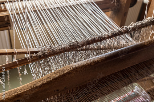 workshop with wooden stells weaving yarn © Normunds