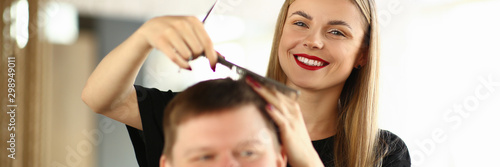 Smiling Hairdresser Combing Hair of Male Client