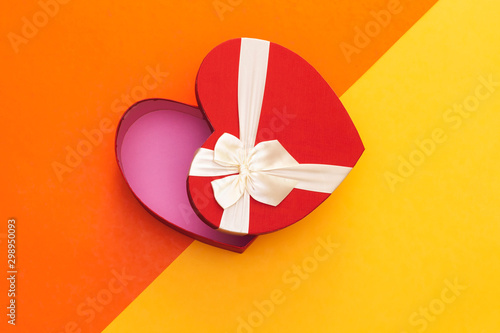 open heart shaped box on colorful background