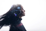 Portrait of beautiful woman with flowing hair in headphones listening music with closed eyes. Double exposure of female face and galaxy isolated on white background. Digital art.