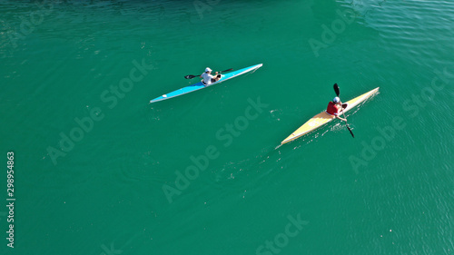 Aerial drone photo of sport canoe competing in tropical exotic green lake