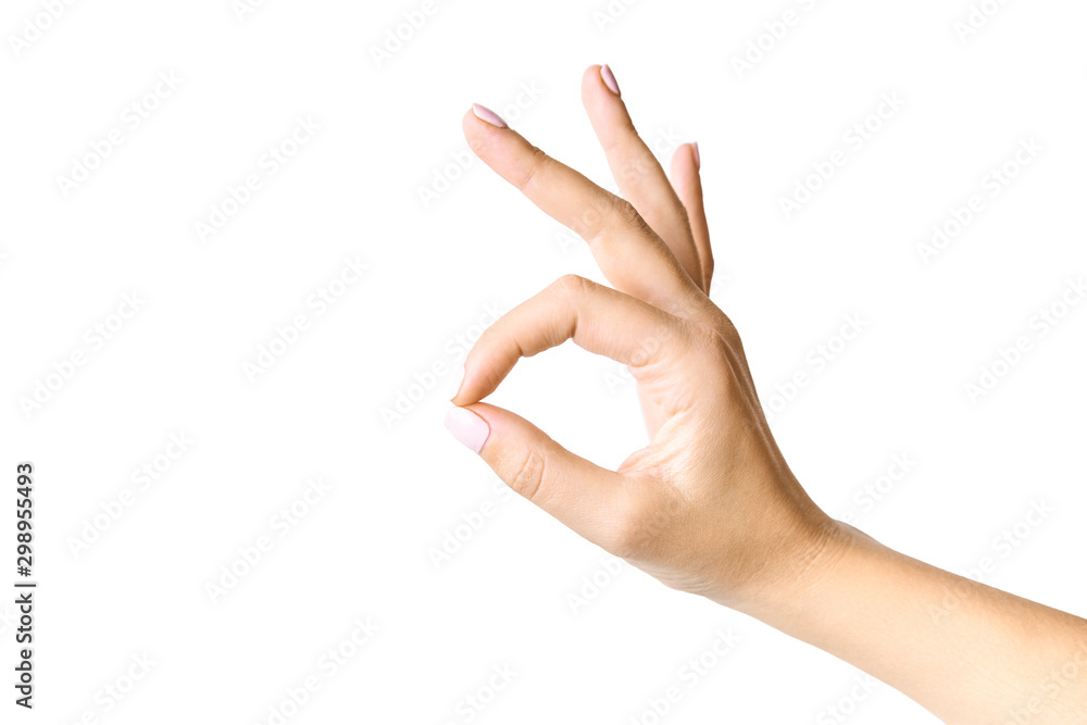 Beautiful female hand gesturing. Okay symbol. Isolated on white background. Beautiful female hand gesturing. Okay symbol. Isolated on white background.