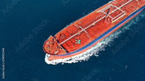 Aerial photo of industrial oil and fuel tanker cruising deep blue Mediterranean sea