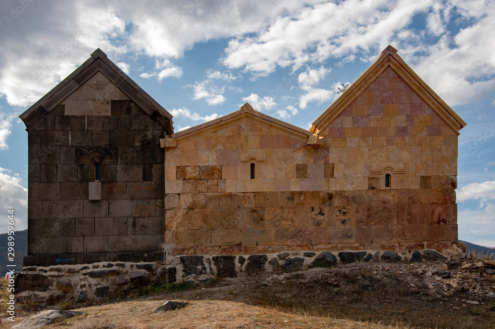 Monastery of light and dark stone against the cloudy sky. Monastery of light and dark stone against the cloudy sky.
