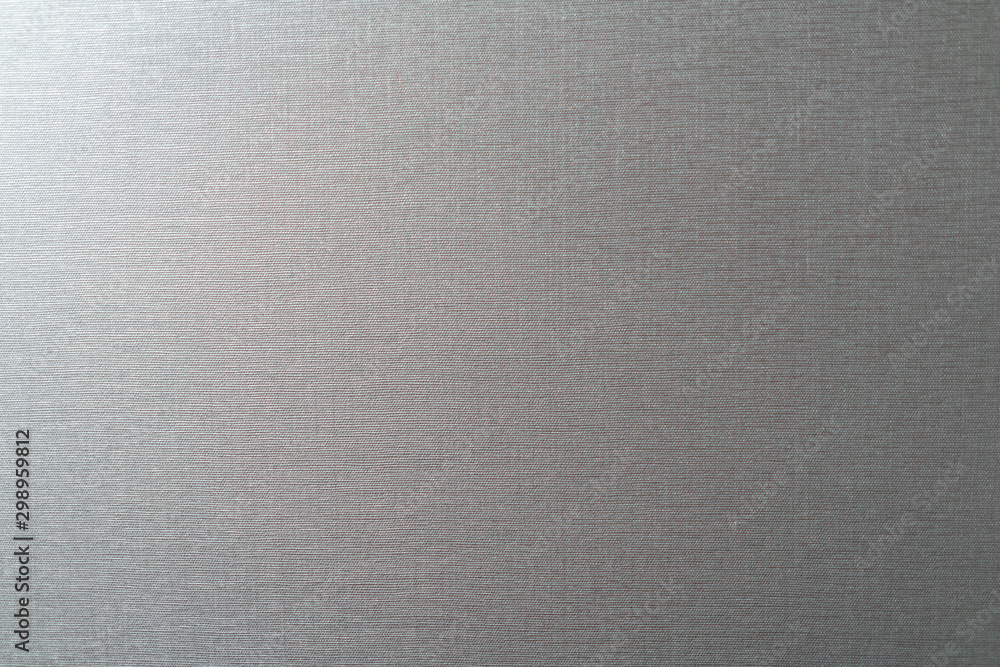 fabric background with hard threads gray lit on one side. fabric background with hard threads gray lit on one side.
