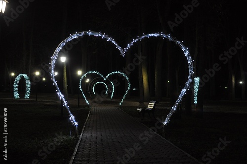 Night alley with luminous hearts.