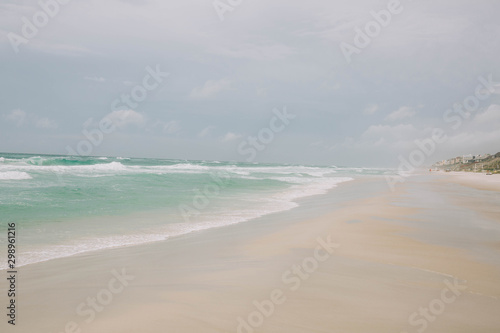 Fototapeta Naklejka Na Ścianę i Meble -  Beach with light blue water and white sand