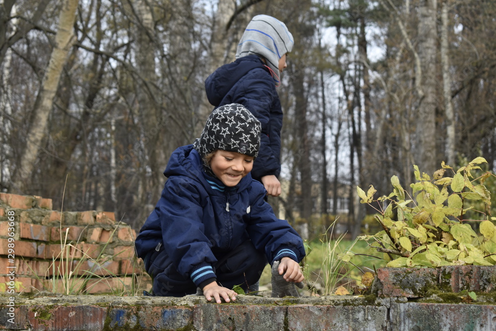 children playing in autumn park children playing in autumn park