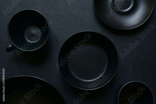 Culinary background with empty black tableware. Top view.
