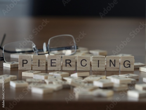 The concept of Piercing represented by wooden letter tiles photo