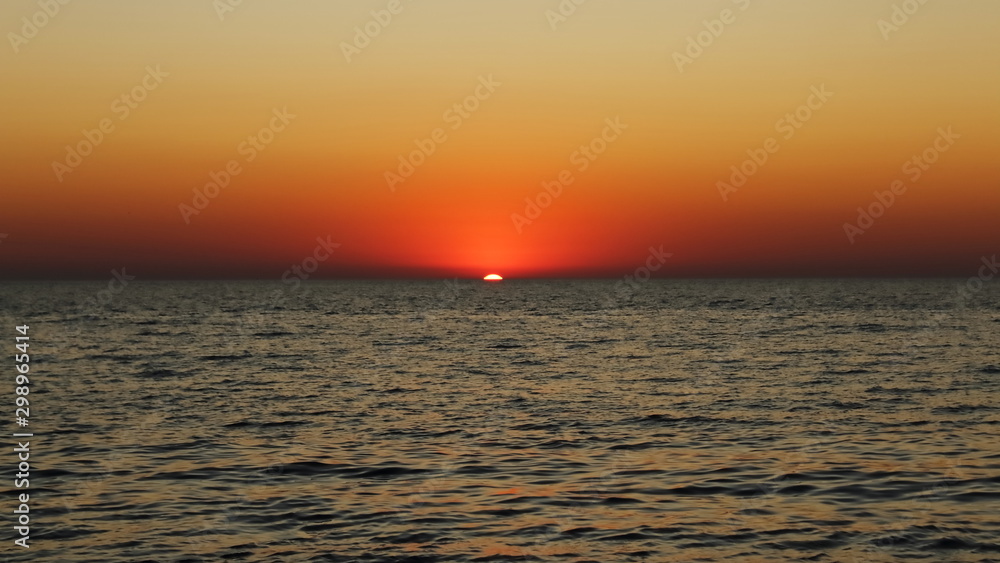 amazing sunset in the sea in red and dark colors