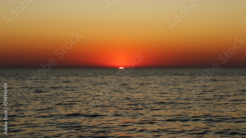 amazing sunset in the sea in red and dark colors © VADZIM