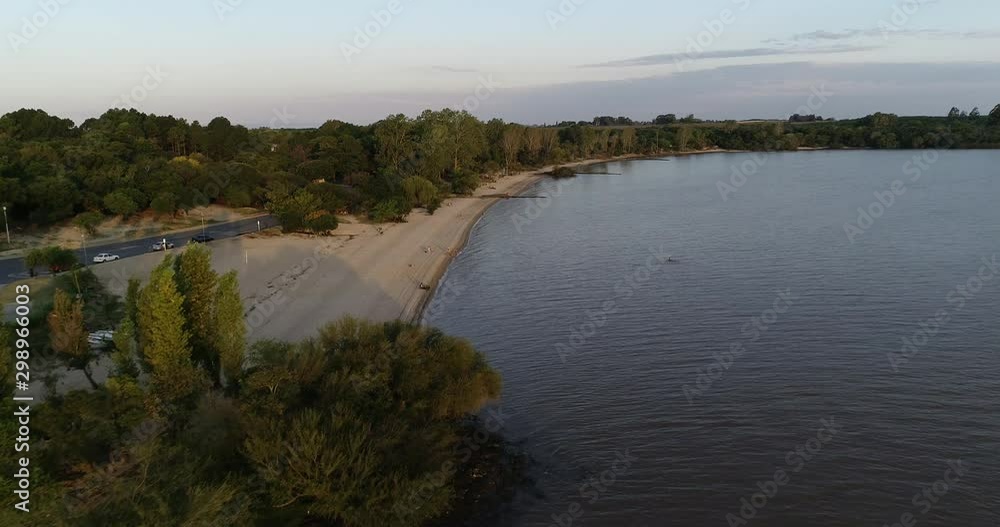 Aerial drone scene of beach at natural landscape. Flying along shore of Uruguay river. Las Cañas, Rio negro province, Uruguay Aerial drone scene of beach at natural landscape. Flying along shore of Uruguay river. Las Cañas, Rio negro province, Uruguay