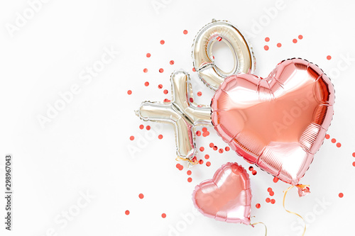Fototapeta XO foil balloon letters and air balloons of heart shaped. Love concept. Holiday and celebration. Valentine's Day or wedding/bachelorette party decoration. Colorful Metallic air balloons.