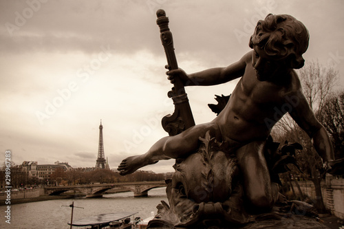 Bronze cherub sculpture on Seine River, Paris © AngelaCapitan