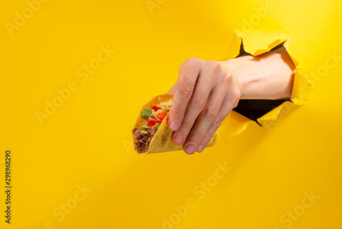 Hand holding a taco