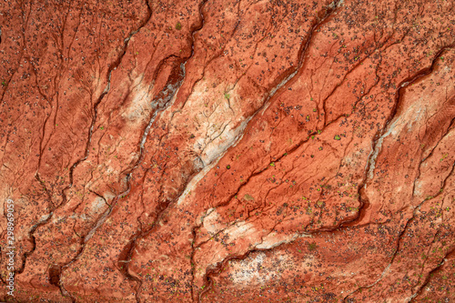 Aerial view of dried out red clay dirt with cracks in clay quarry.