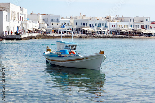 small traditional fishing boat in the port of Mykonos, the famous Greek island of Cyclades in the heart of the Aegean Sea