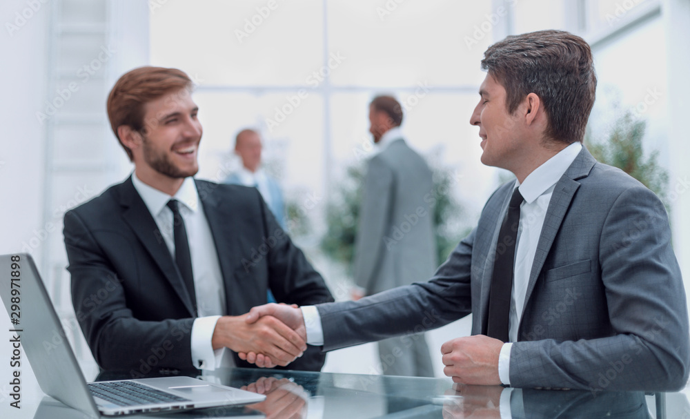 close up. handshake of business people at the Desk close up. handshake of business people at the Desk