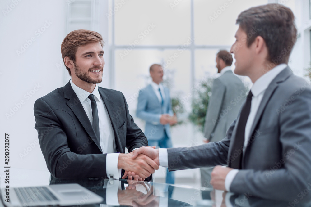 close up. handshake of business people at the Desk close up. handshake of business people at the Desk
