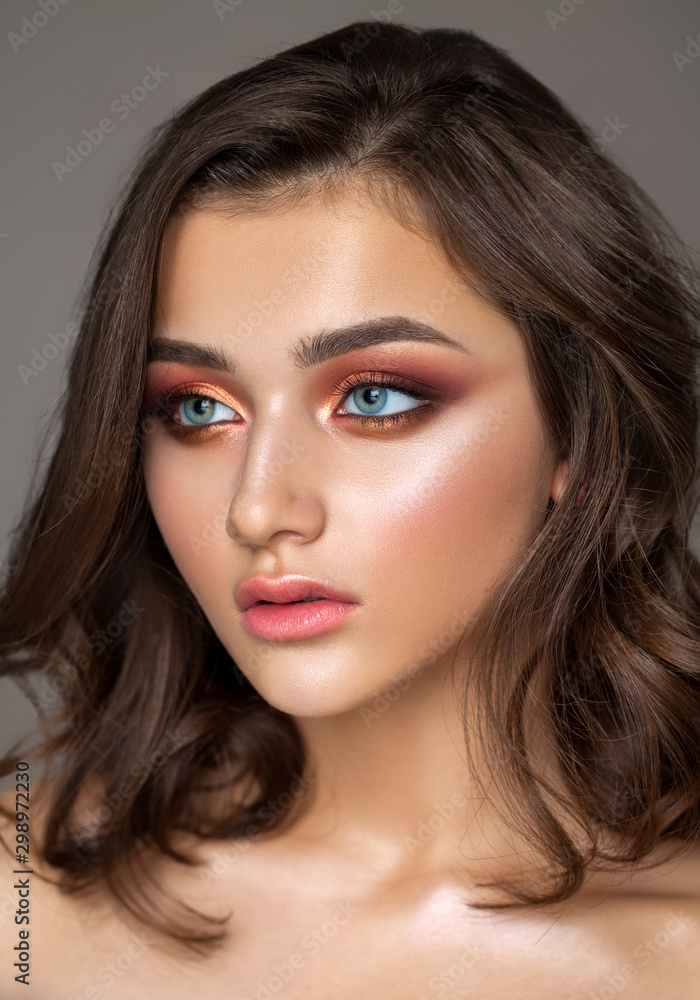 Beautiful young model with colorful trendy smoky eyes, bright blue eyes and natural hairdo Beautiful young model with colorful trendy smoky eyes, bright blue eyes and natural hairdo