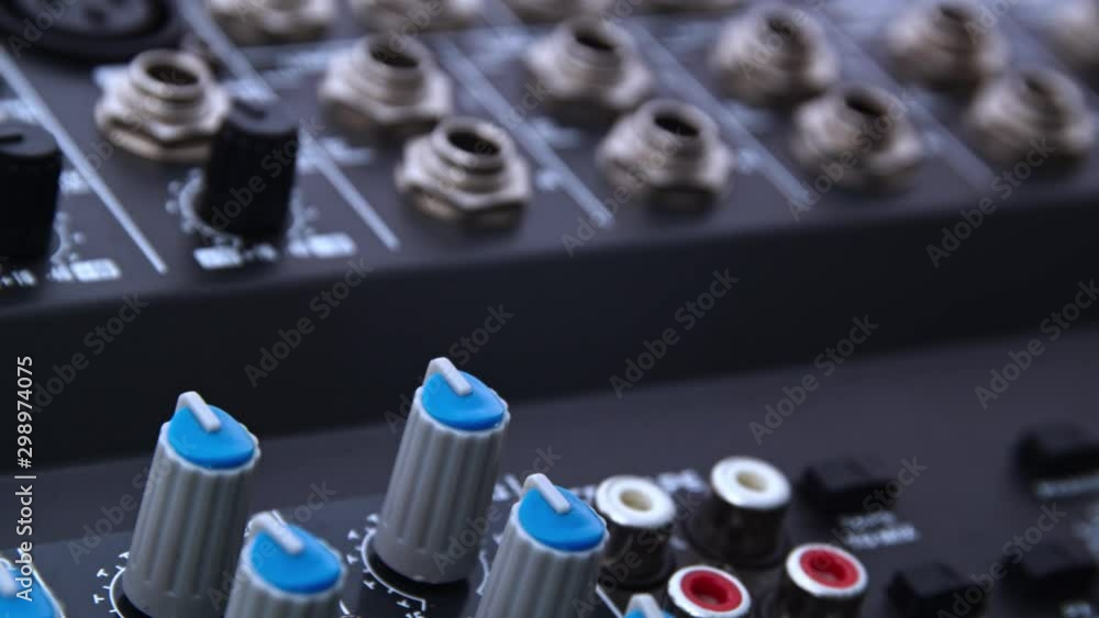 Audio gain channel knobs on a professional board mixer, closeup moving shot Audio gain channel knobs on a professional board mixer, closeup moving shot