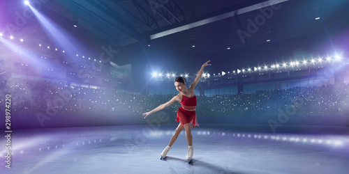 Figure skating girl in ice arena. photo