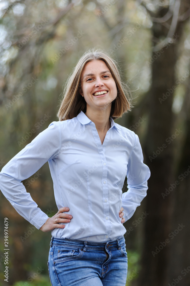 Casually dressed smiling business woman on a nature background Casually dressed smiling business woman on a nature background