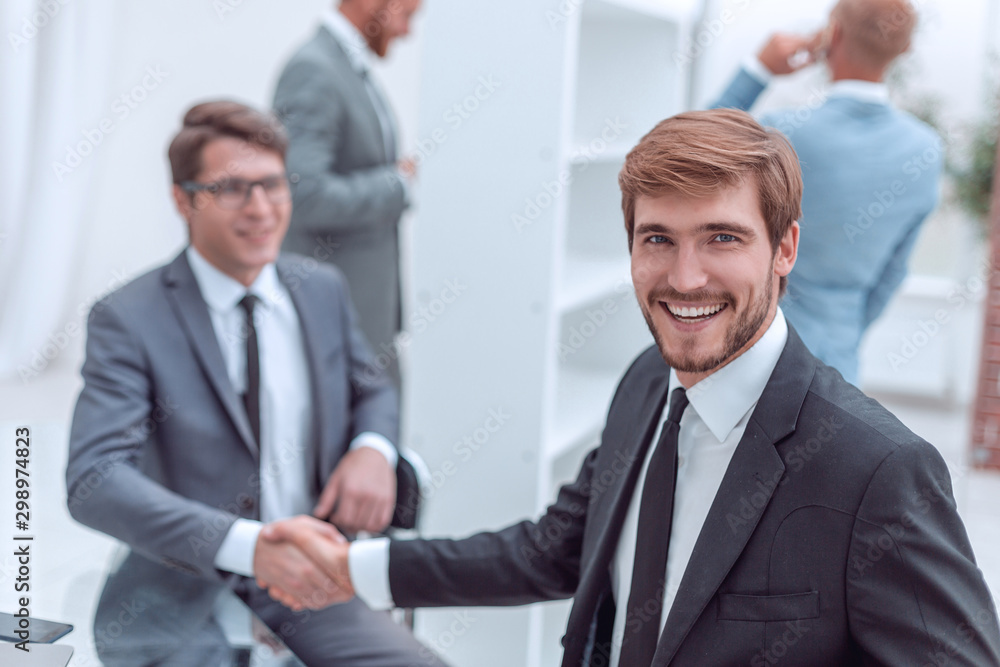 happy entrepreneur shaking hands with his business partner happy entrepreneur shaking hands with his business partner
