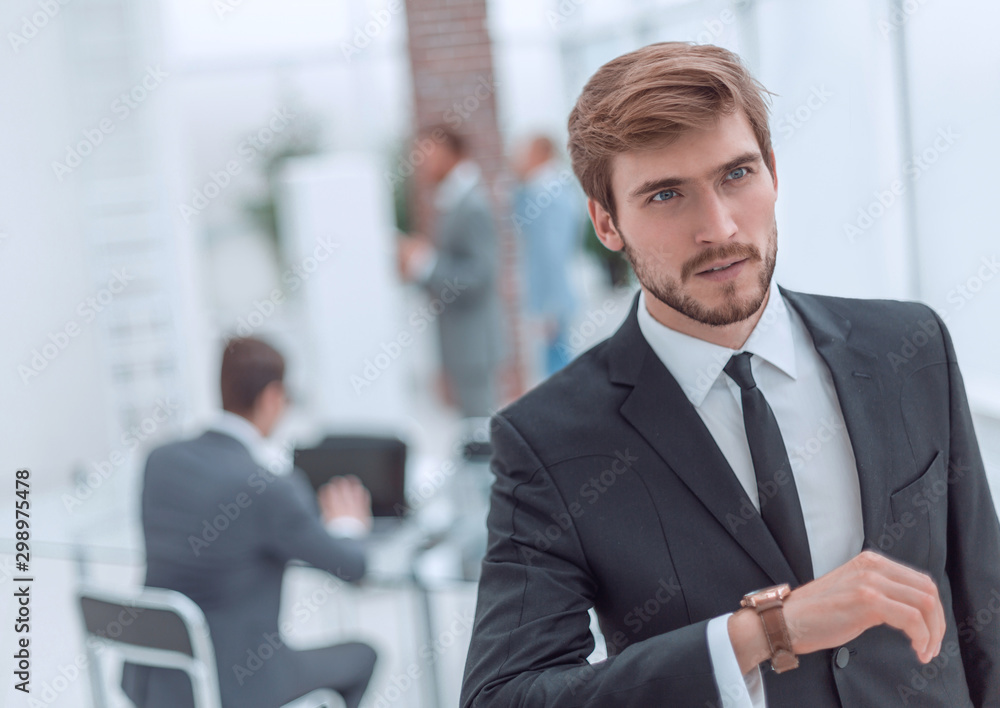 serious businessman looking at his wrist watch. serious businessman looking at his wrist watch.