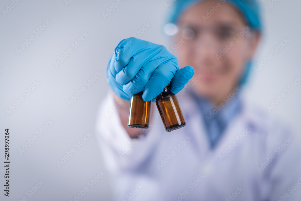 scientist with equipment and science experiments ,laboratory glassware containing chemical liquid for design or decorate science or other your content and selective focus scientist with equipment and science experiments ,laboratory glassware containing chemical liquid for design or decorate science or other your content and selective focus