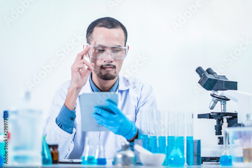 Asian scientist has researching in laboratory  chemical lab