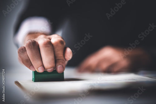 Fotografie Close-up Of A Person's Hand Stamping With Approved Stamp On Text Approved Docume