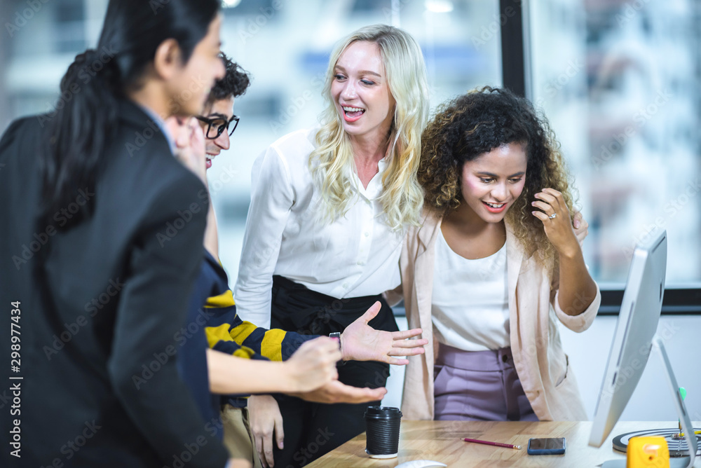 Business staff meeting. Group of young modern people in smart casual wear discussing something while working in the creative office Business staff meeting. Group of young modern people in smart casual wear discussing something while working in the creative office