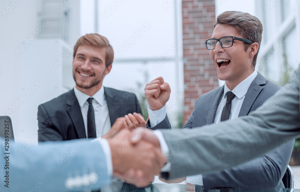 handshake of business people on a blurred office background. handshake of business people on a blurred office background.