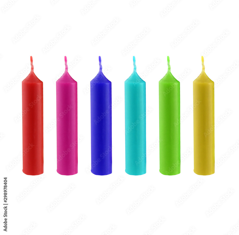 Fototapeta premium Christmas candles in different color. They are decorative candles. It's a set of xmas candles in red, purple, blue, green and yellow
