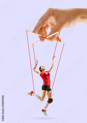 Foto Woman like a puppet in somebodies hands on purple background